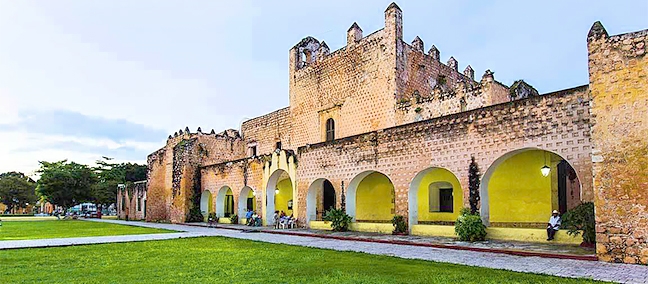 People relaxing in a vibrant town square with manicured trees